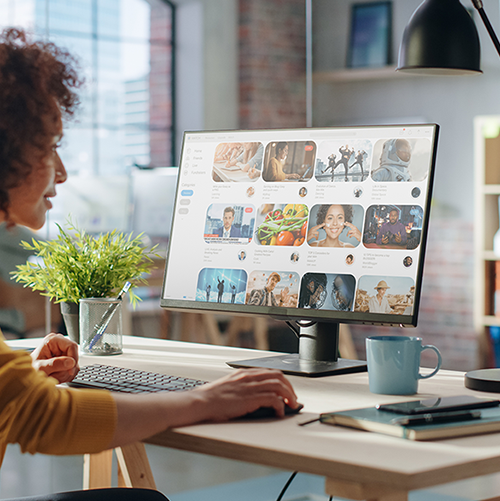 graphic designer at desk with view of screen