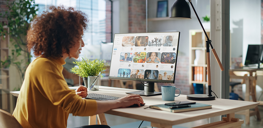 graphic designer at desk with view of screen